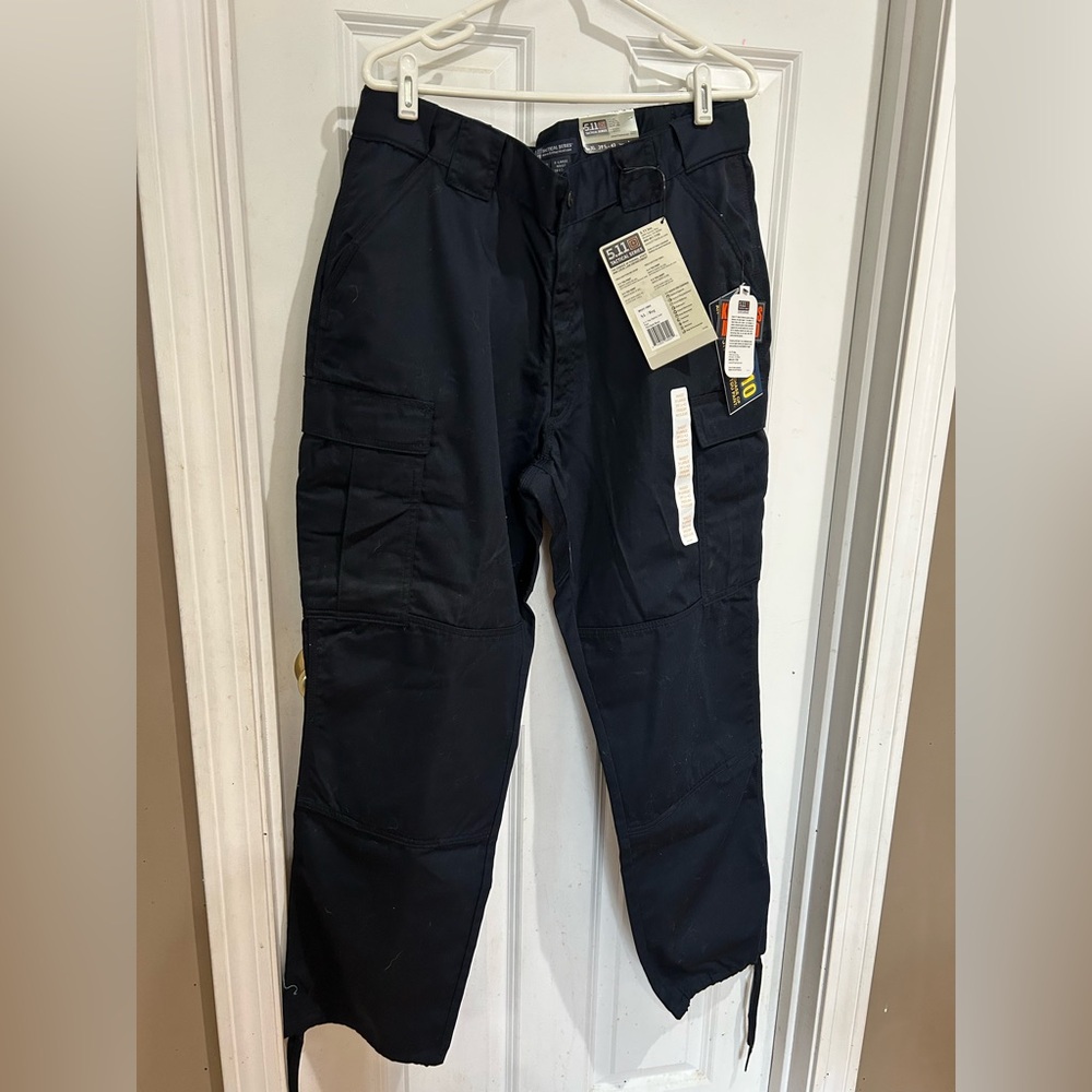 5.11 tactical series pants. Size XL/regular. Color is dark navy.